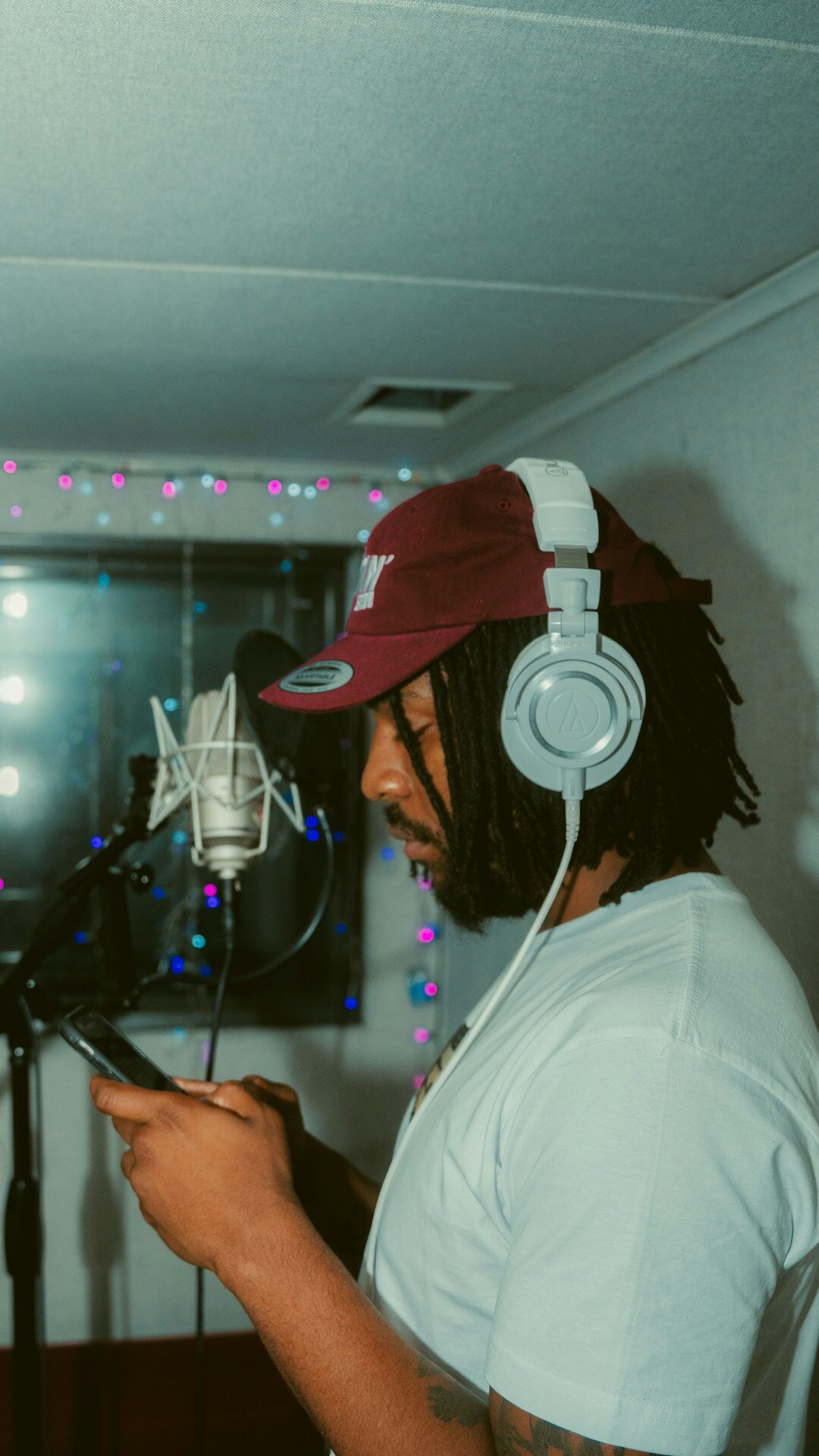 Podcast host wearing headphones recording an interview in a studio